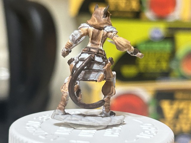 Image of a black tabaxi miniture with leather armor.